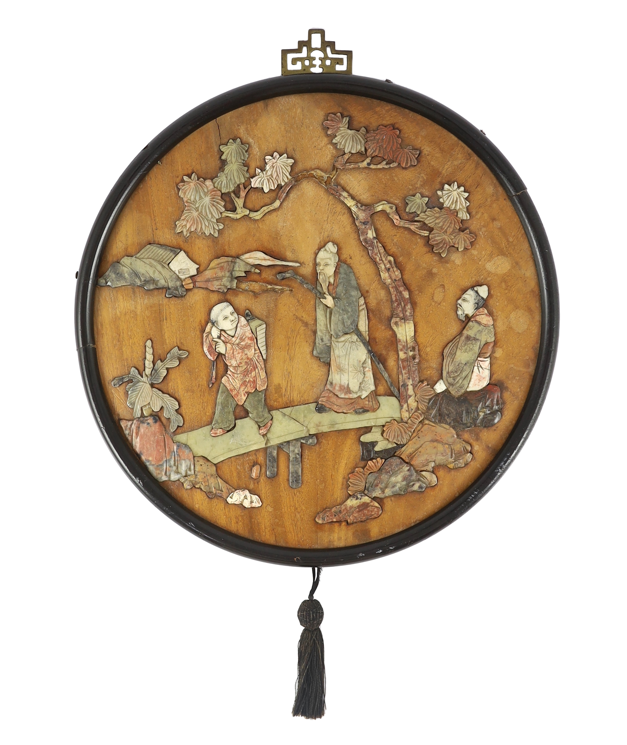 A Chinese wood and soapstone inlaid circular screen panel, late Qing dynasty